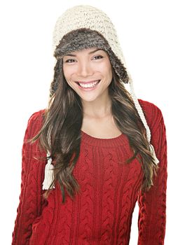 Beautiful winter woman portrait. Asian happy girl posing with winter sweater and knit hat on white background.