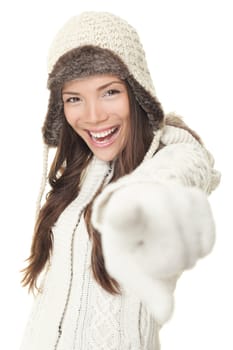 Woman in winter clothing pointing screaming of joy. Beautiful happy young asian caucasian girl isolated on white background.