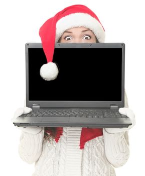 Christmas internet shopping. Woman in santa hat shocked holding computer with blank screen for advertising message