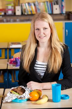 Attractive blond student with a healthy take away school lunch