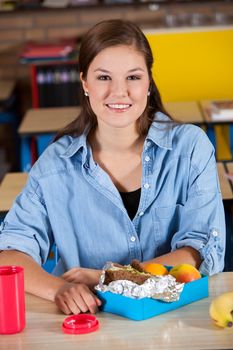 Student sitting in the class room with a healthy lunch in front of her