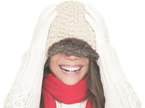 Winter fun. Woman smiling playful in winter hat. Portrait isolated on white background.
