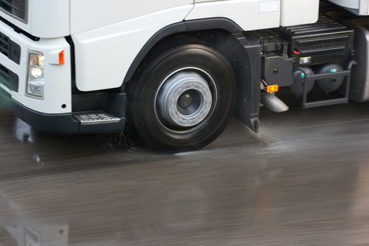 Truck moving fast on wet road