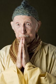 Guru praying with hands and looking up