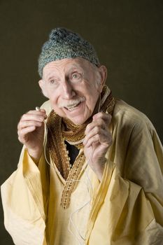 Guru listening to personal handheld audio device