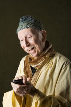 Wise Man with Knit Cap Using Cell Phone