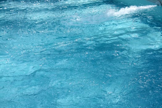 A background of pure water being pumped into a swimming pool.