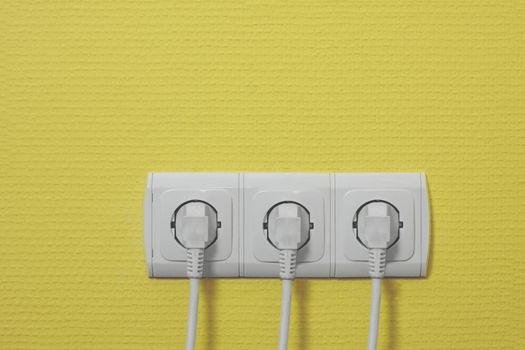 Three electric outlets with cables connected