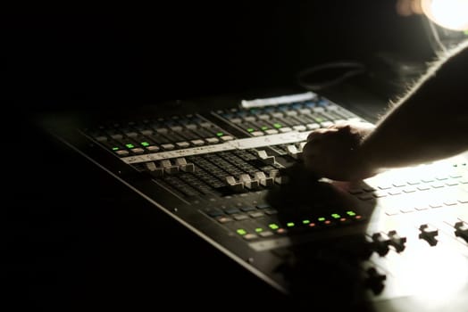 Soundboard mixer at concert at night