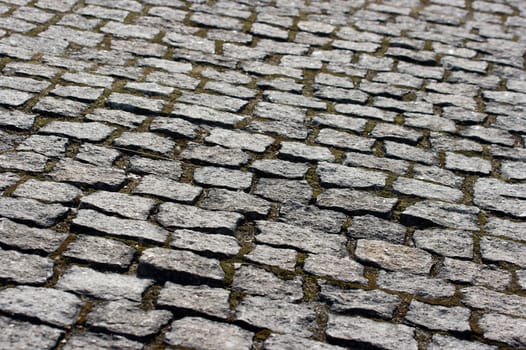 Old stone pavement closeup, small stones