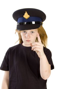 young girl with police hat is giving a warning sign on white