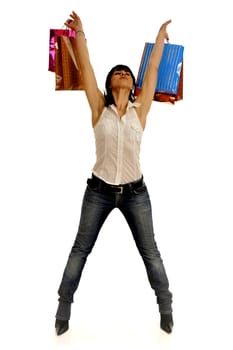 Full body view of young attractive woman going shopping with lots of colorful shopping bags. Isolated on white background.