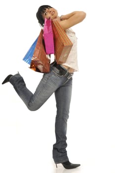 Full body view of young attractive woman going shopping with lots of colorful shopping bags. Isolated on white background.