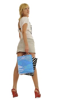 Full body view of young attractive woman going shopping with lots of colorful shopping bags. Isolated on white background.