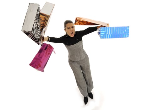 Full body view of young attractive woman in business wear,  going shopping with lots of colorful shopping bags. Isolated on white background.