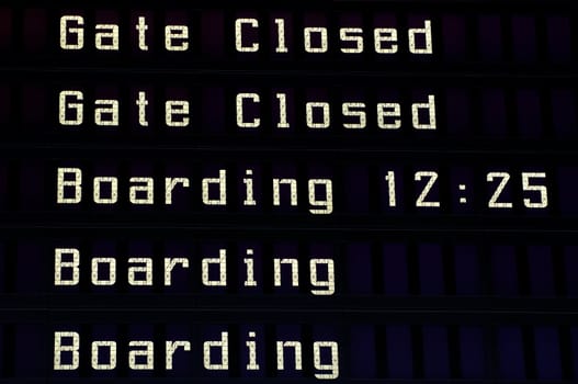 Airport information board, boarding announcement.