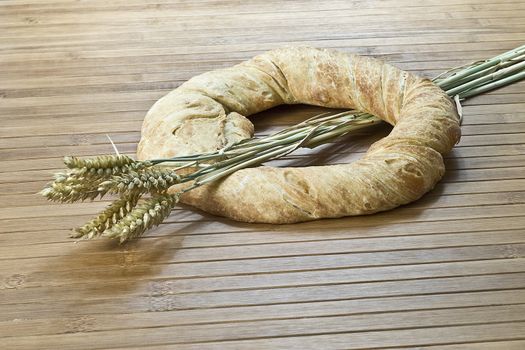 Some types of bread on a bamboo background.