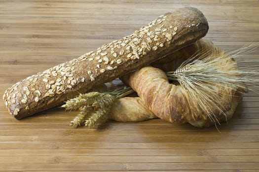 Some types of bread on a bamboo background.