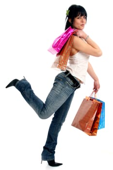 Full body view of young attractive woman going shopping with lots of colorful shopping bags. Isolated on white background.