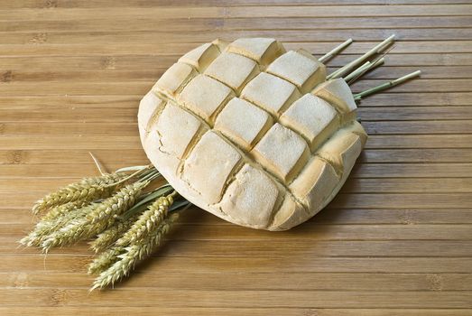 Some types of bread on a bamboo background.