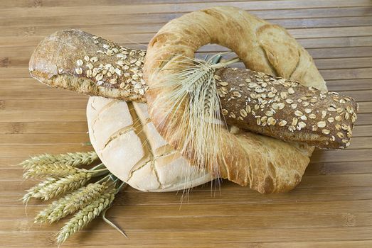 Some types of bread on a bamboo background.