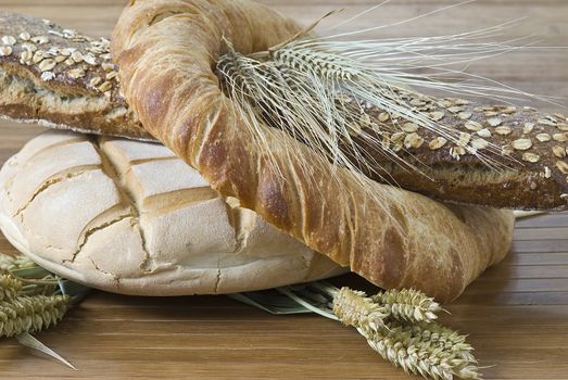 Some types of bread on a bamboo background.