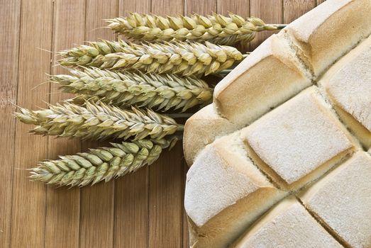 Some types of bread on a bamboo background.