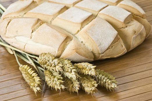 Some types of bread on a bamboo background.