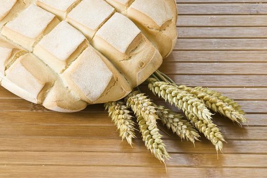 Some types of bread on a bamboo background.