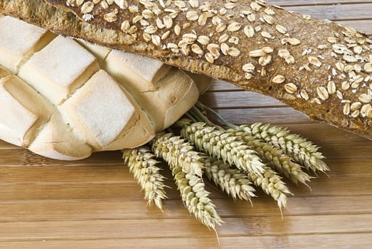 Some types of bread on a bamboo background.