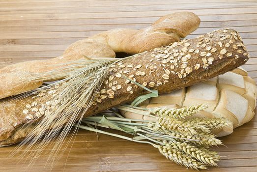 Some types of bread on a bamboo background.