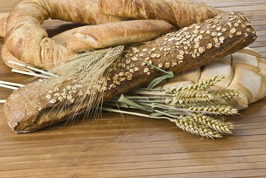 Some types of bread on a bamboo background.