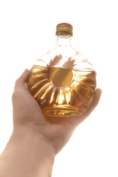 Hand holding decorated bottle with whiskey. Isolated over white.