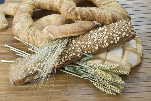 Some types of bread on a bamboo background.