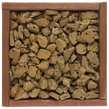 dog food in a primitive wooden box or frame, isolated on white