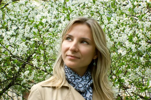 Smiling woman among blooming tree