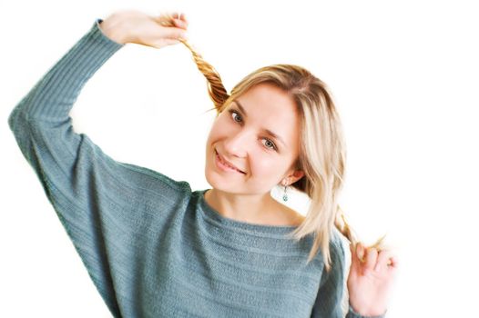 Joyful funny girl with two plaits over white