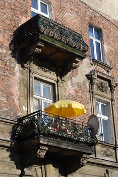 a window with yellow umbrella in krakow, poland, europe