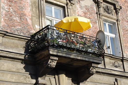 a window with yellow umbrella in krakow, poland, europe