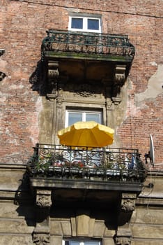 a window with yellow umbrella in krakow, poland, europe