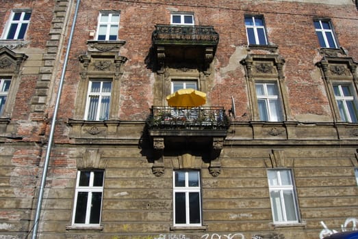 a window with yellow umbrella in krakow, poland, europe