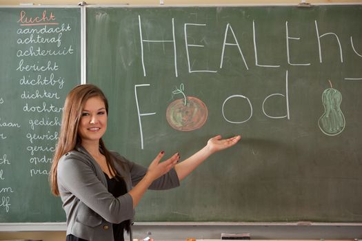 Student in front of the class giving a presentation about healthy food