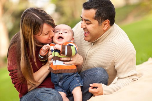 Happy Mixed Race Parents Playing with Their Giggling Son.