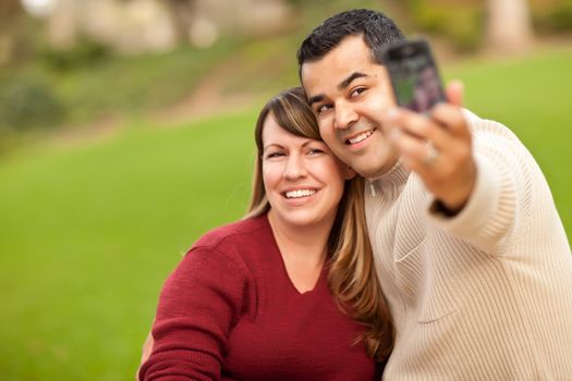 Attractive Mixed Race Couple Taking Self Portraits in the Park.