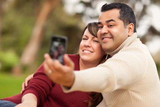 Attractive Mixed Race Couple Taking Self Portraits in the Park.