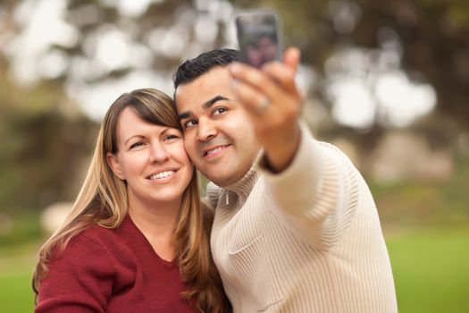 Attractive Mixed Race Couple Taking Self Portraits in the Park.