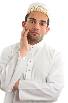 A man wearing cultural ethnic robe and decorative topi thinking.  White background.