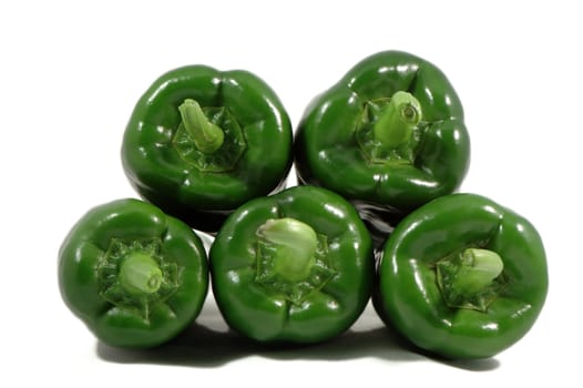 Stack of green papricas isolated over white