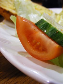 A photograph of close up tomato and cucumber.