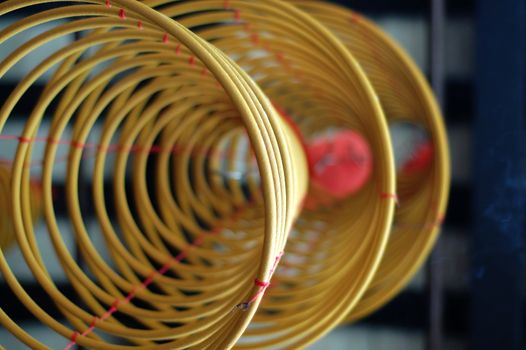 Three big incense coils hanging under the roof of a Chinese temple